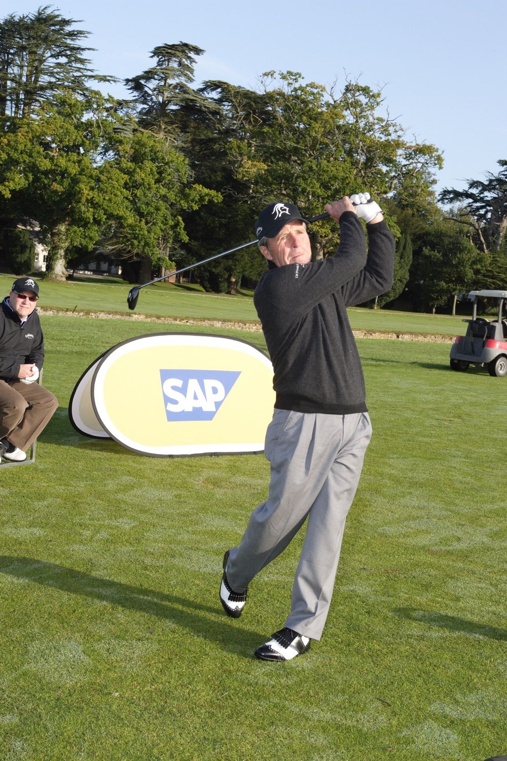 As part of an incentive group, Gary Player gives a group lesson for SAP staff and guests