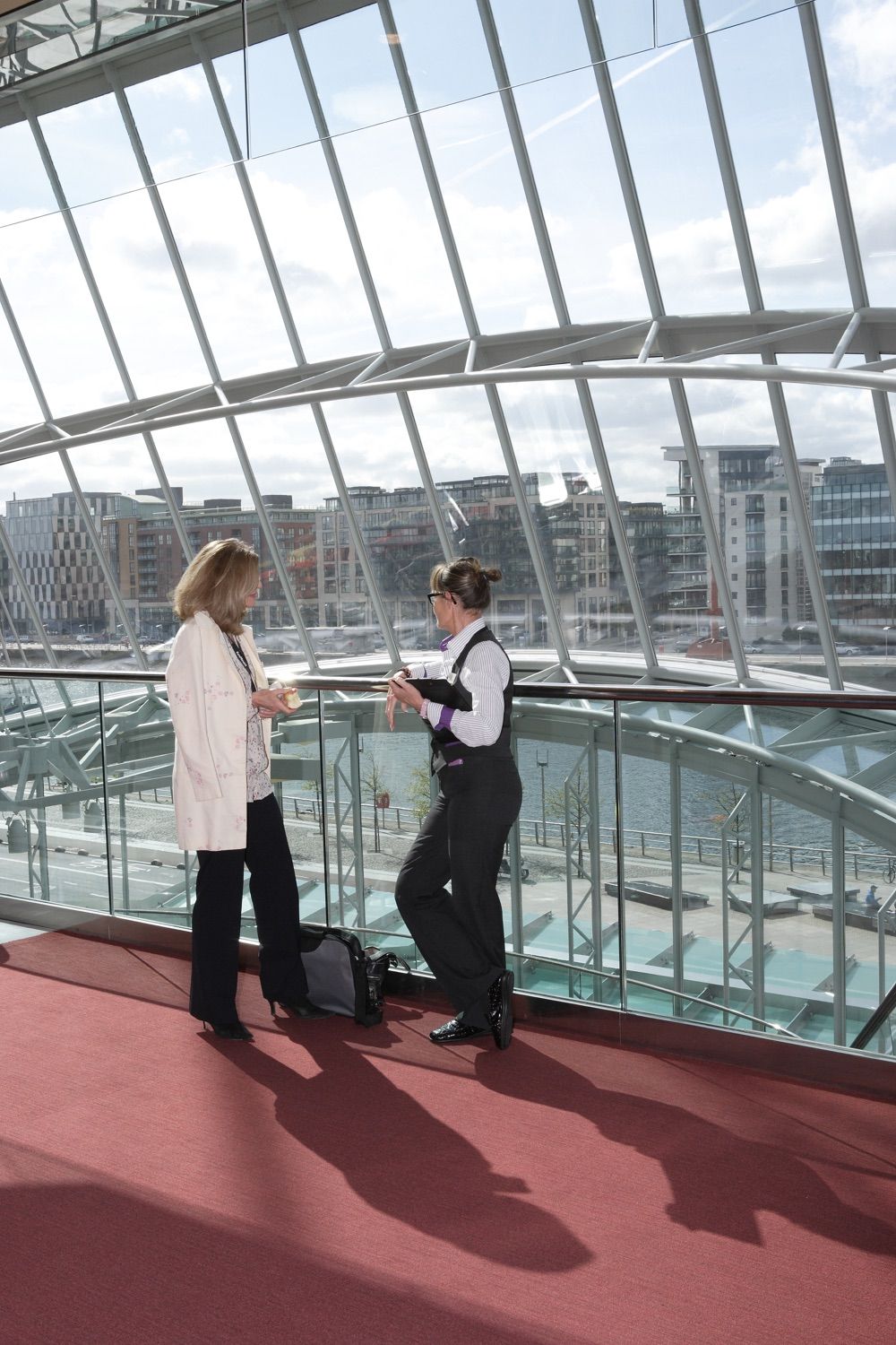 Two ladies admire the view from the upper floors of the Convention Centre Dublin