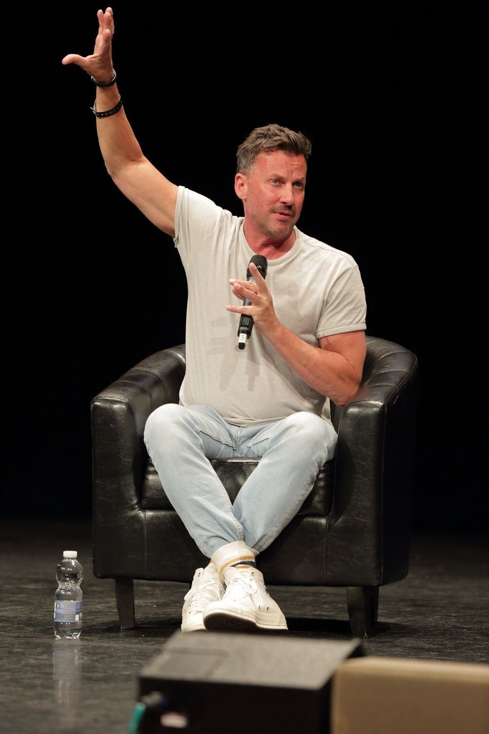 A creator is photographed with his hand in the air at Comicon, held in the Conference Centre Dublin