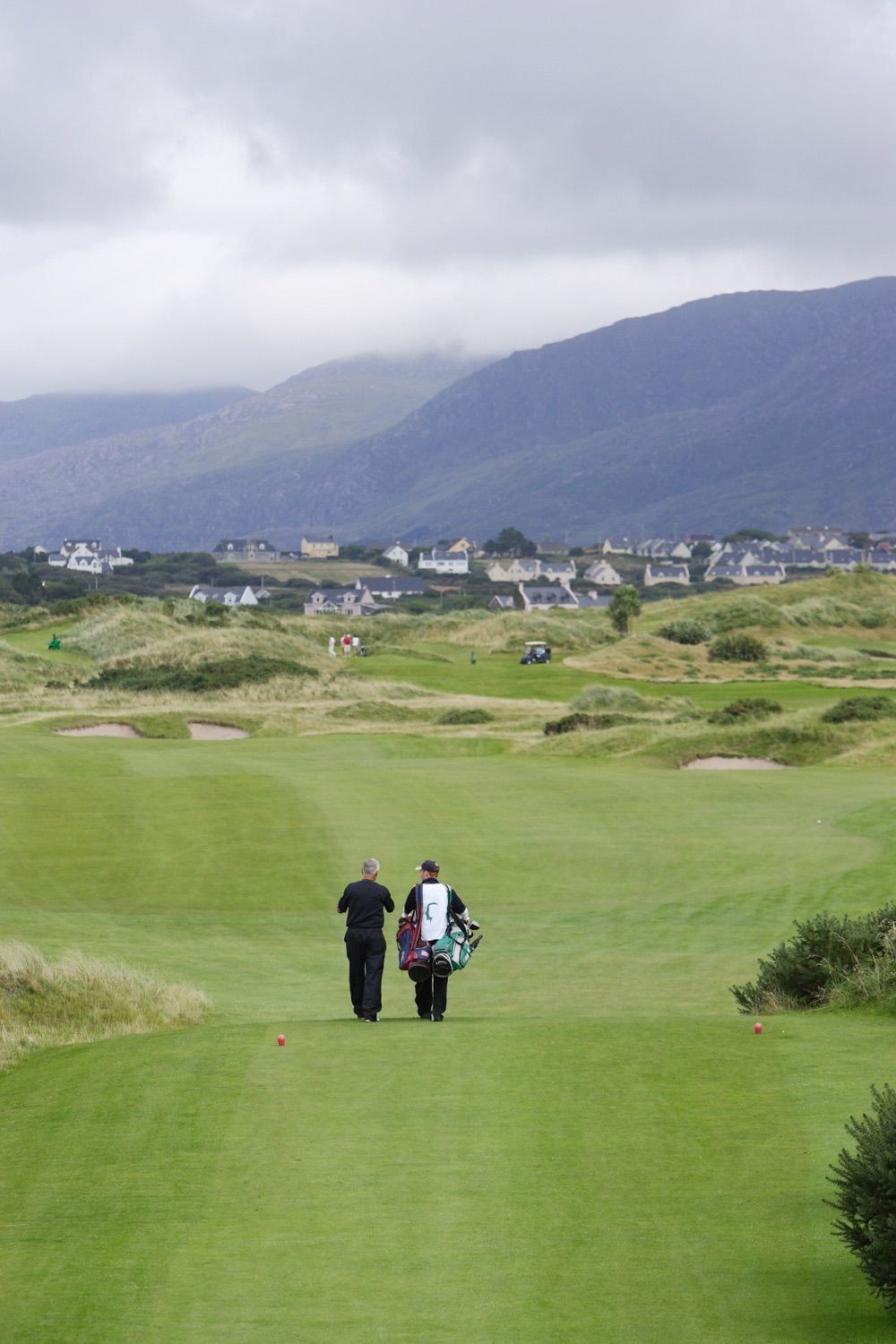 A player and his caddie walk down the fairway at Waterville Gold Club in County Kerry