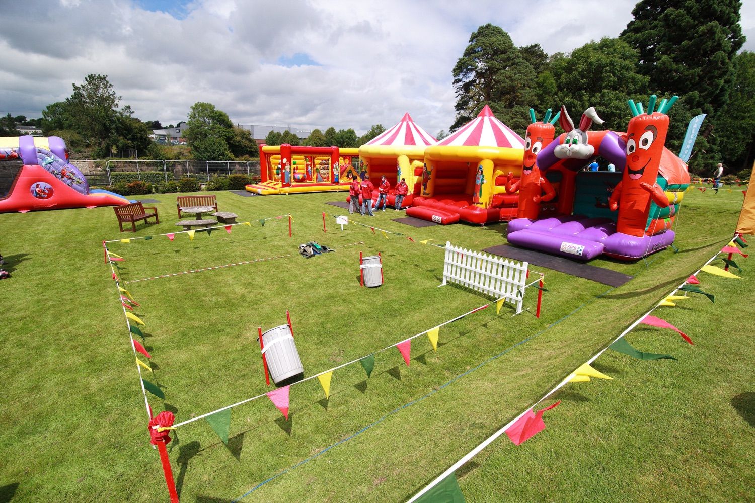 A photograph of the inflatable bouncy castles and entertainment booths set up for a company family fun day