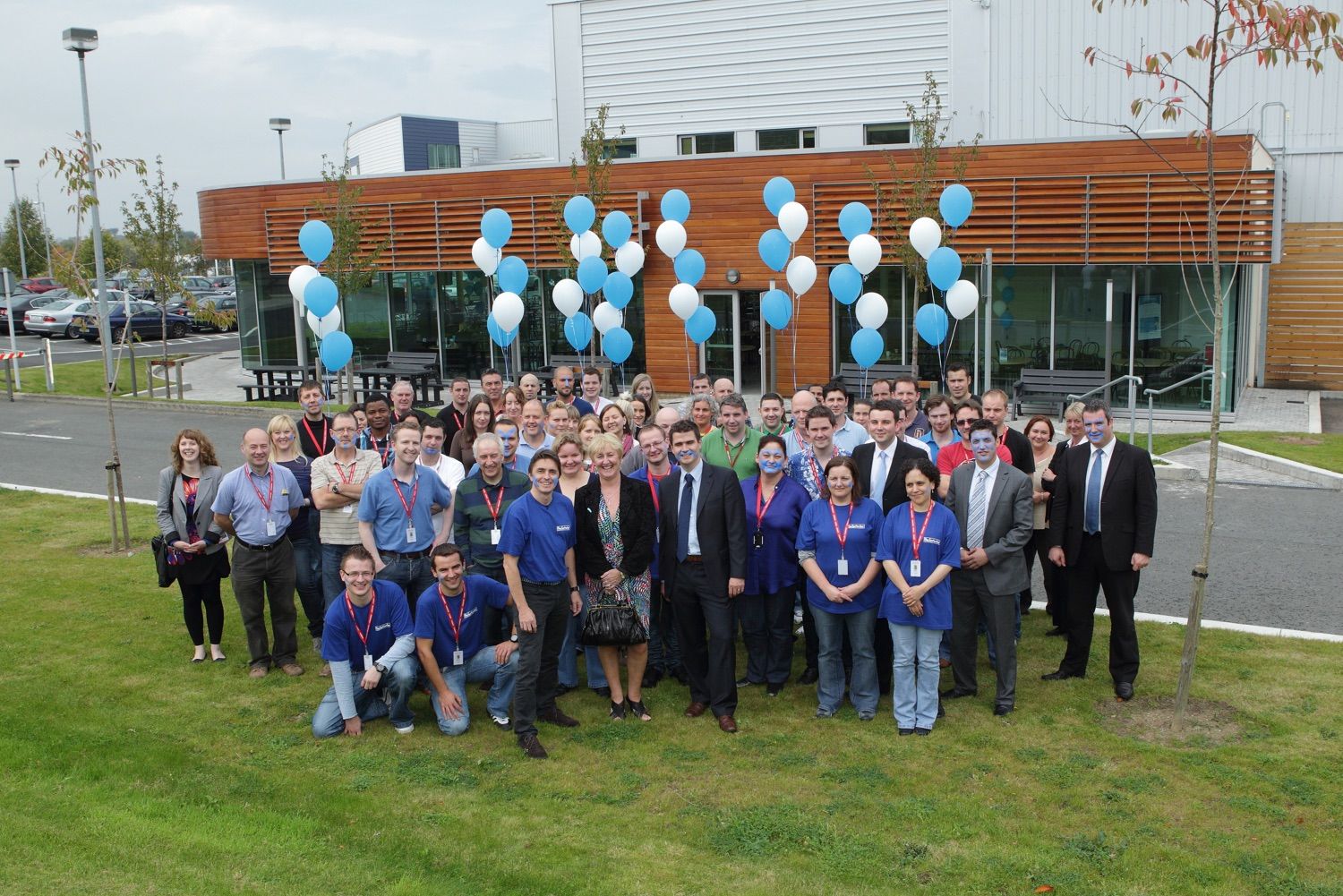 Staff and management get together for a group photo at their business centre