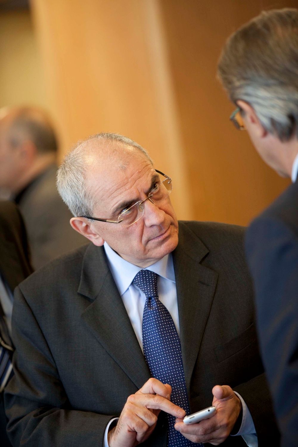 A delegate pays close attention to another delegate during a break in a conference in the Dublin Convention Centre