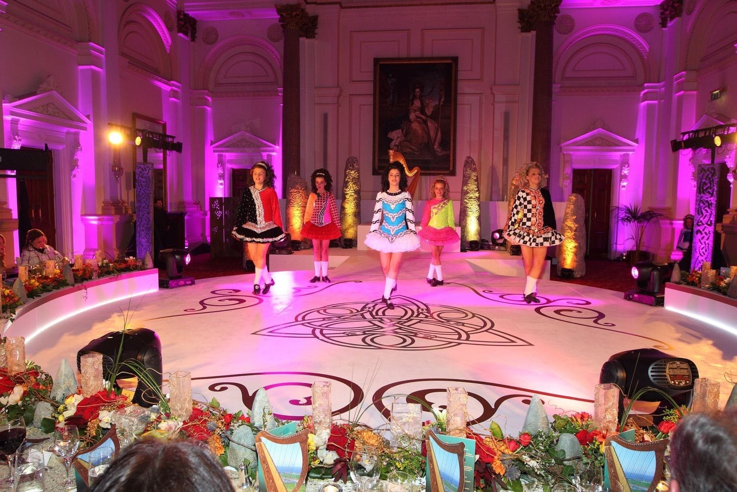 Irish dancers entertain the guests at an exclusive party in front of the portrait in the banking hall of the College Green Hotel, Dublin