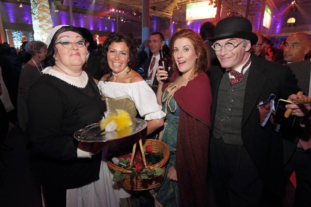 A selection of characters who mingle with the guests at a large corporate party in the Royal Dublin Society, Dublin