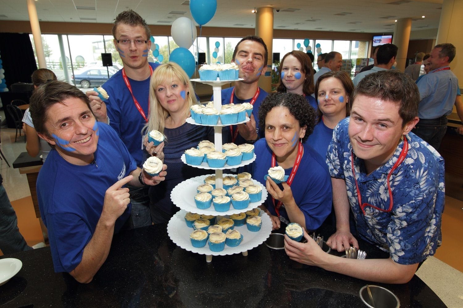 Staff and management get to have some fun and eat cup cakes to celebrate