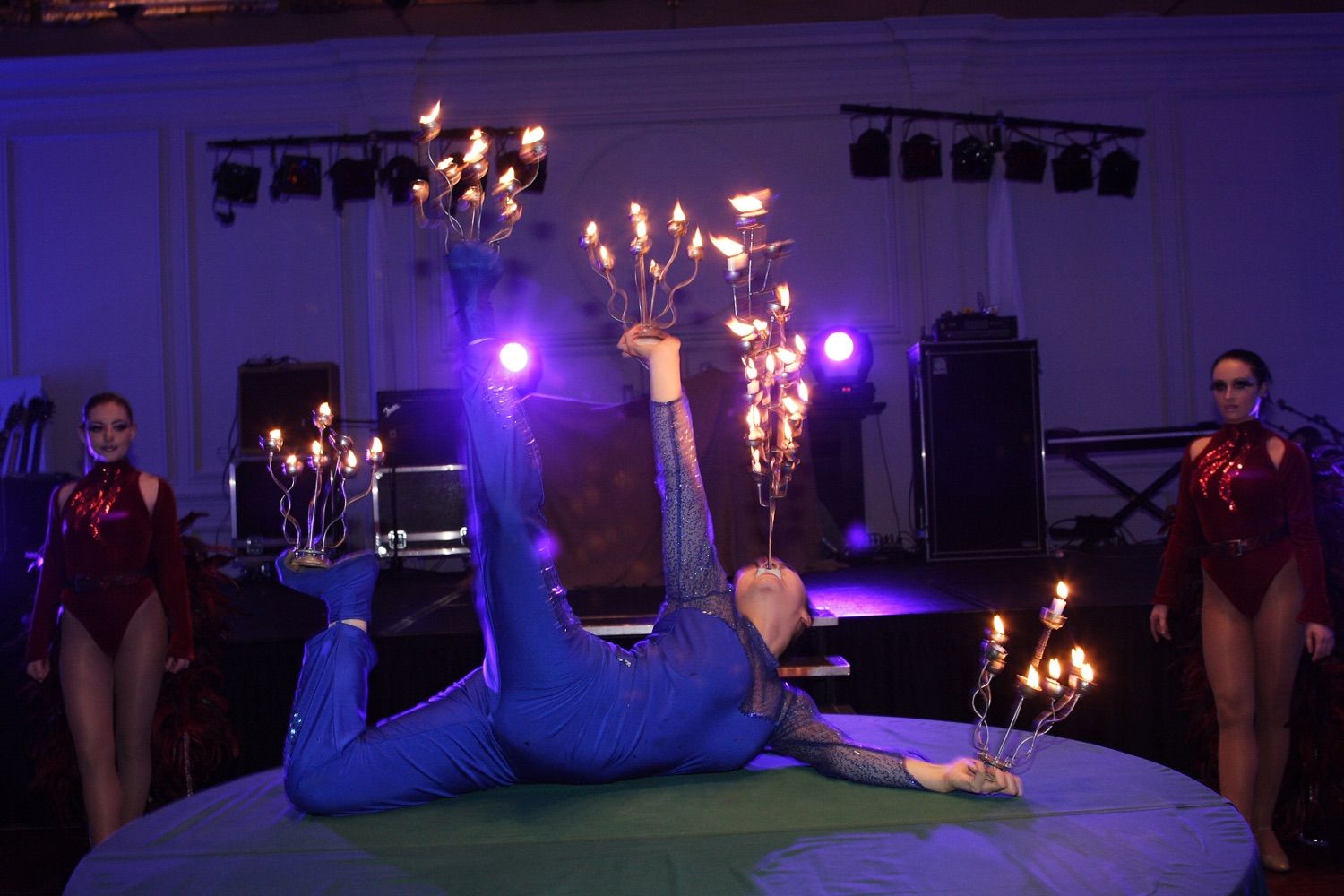 A circus contortionist balances candlarberas on her feet, hands and mouth at a corporate party in the Royal Hospital, Kilmainham