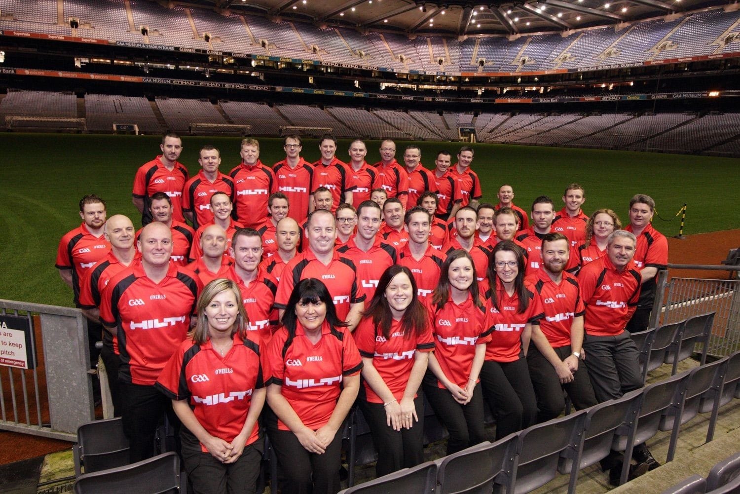 A group photograph of Hilti staff beside the pitch in Coke Park GAA stadium, during their annual sales conference