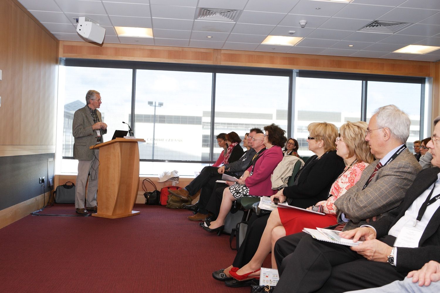 A photograph of the speaker and front row of a small break out session in the Convention Centre Dublin