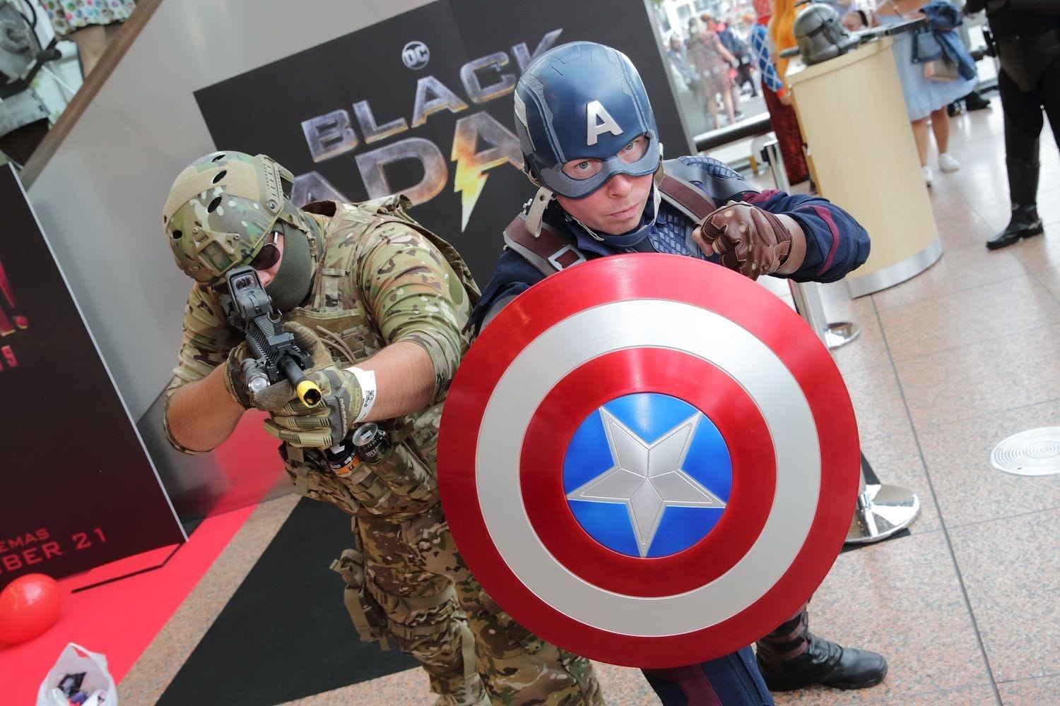 Captain America stands behind his shield with an American solider at his shoulder at Comicon, held in teh Conference Centre Dublin