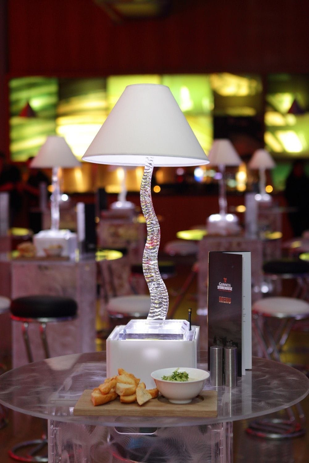 A lamp and finger food on a perspex table at a corporate party iin the Guinness Storehouse, Dublin