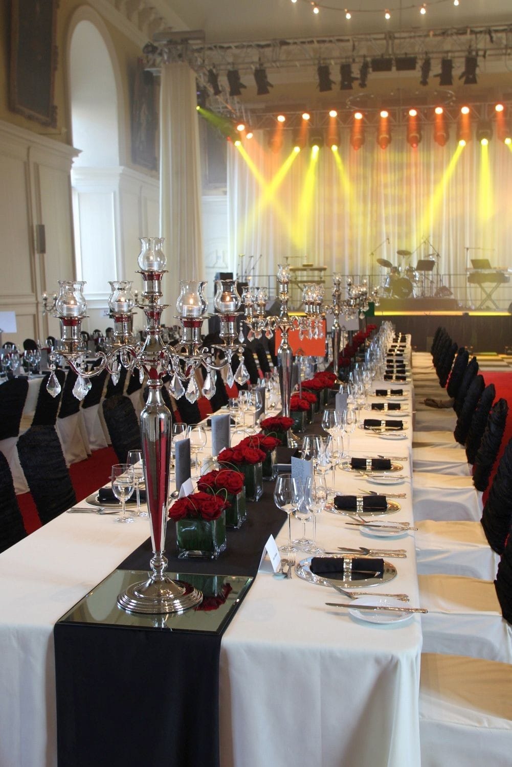 A photograph showing the room, the stage, lighting and table decor in the Royal Hospital, Kilmainham