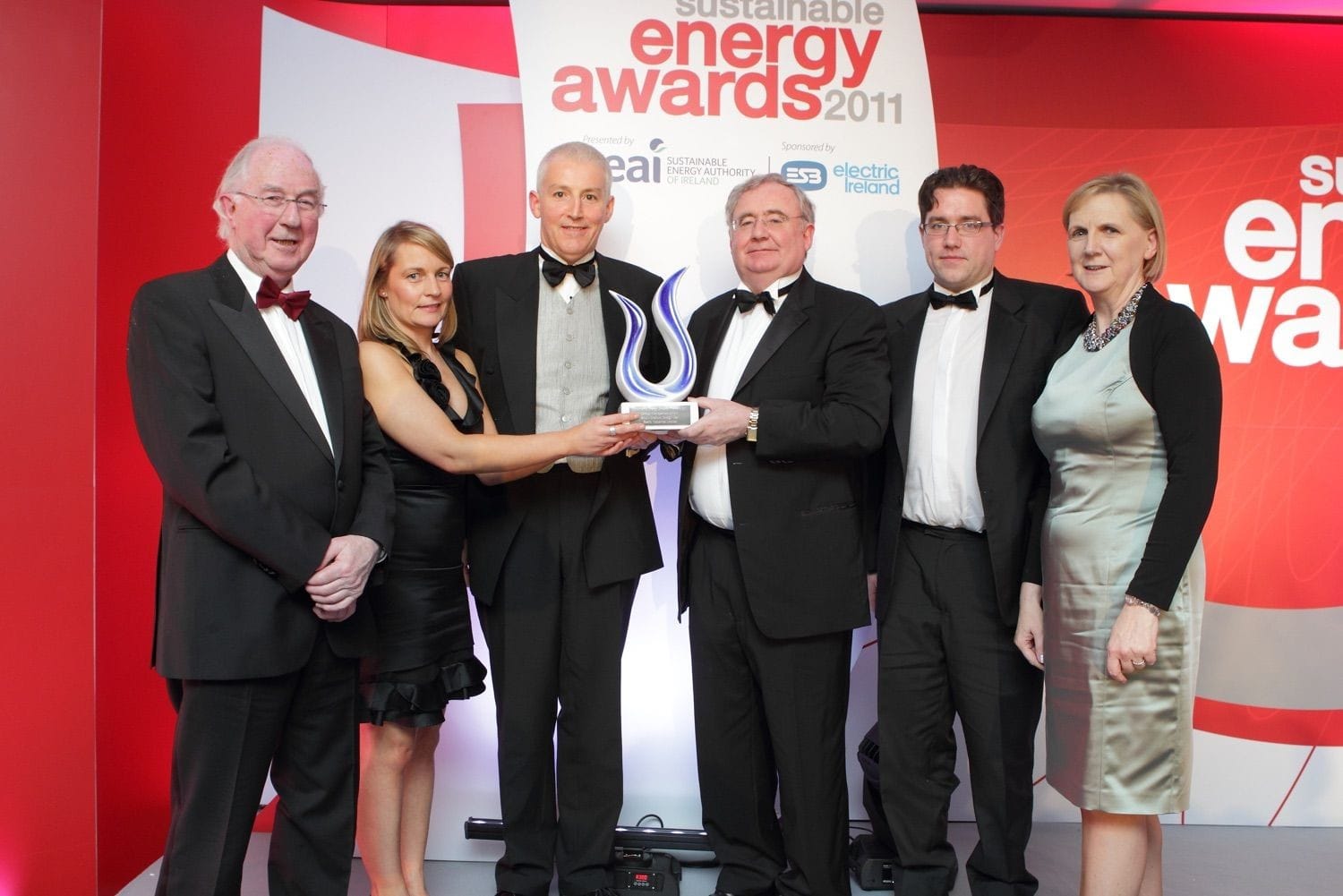 A group photograph of winners receiving their award at the Sustainable Energy Awards