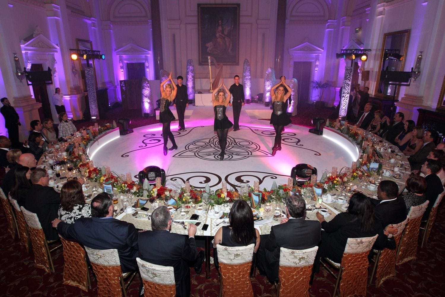 Irish dancers entertain the guests at an exclusive party in front of the portrait in the banking hall of the College Green Hotel, Dublin