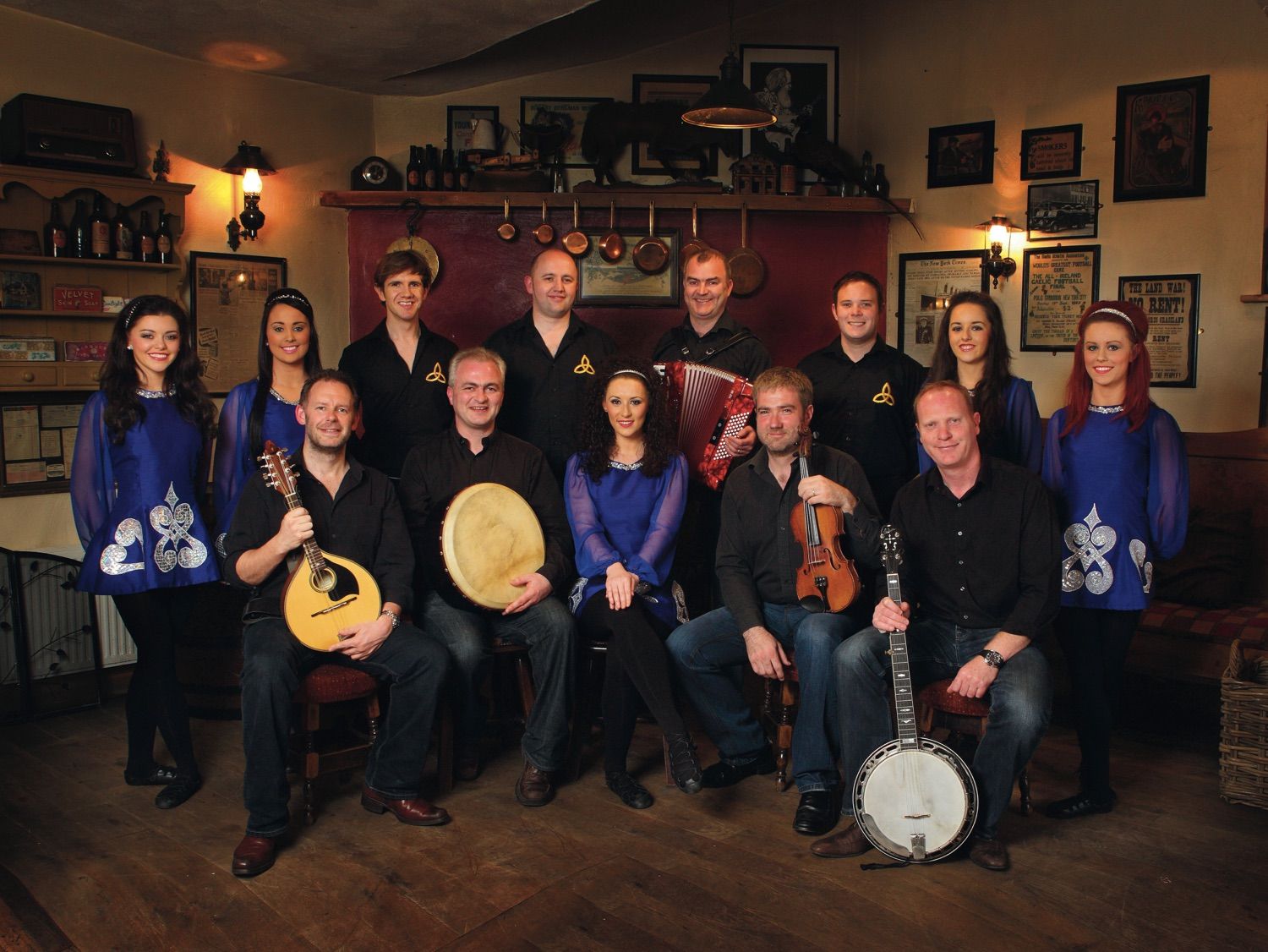 A photograph of the Irish trad band 'The Merry Ploughboys' and their Irish dancers