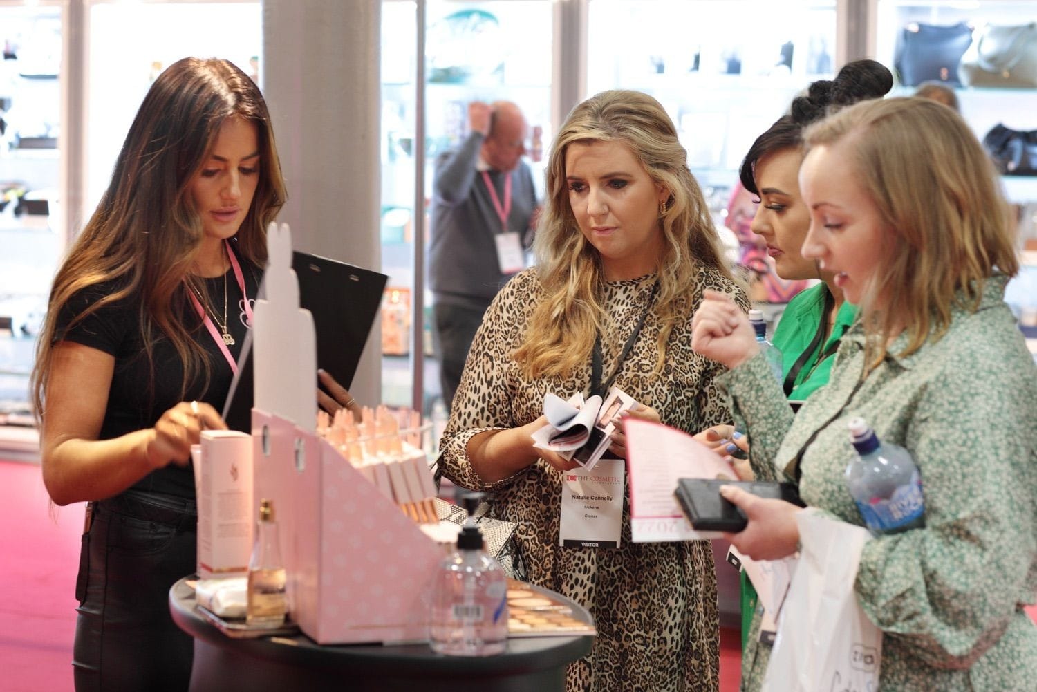 A helpful member of staff explains the range of produycts to three lady buyers at a trade show in the main hall of the RDS, Dublin