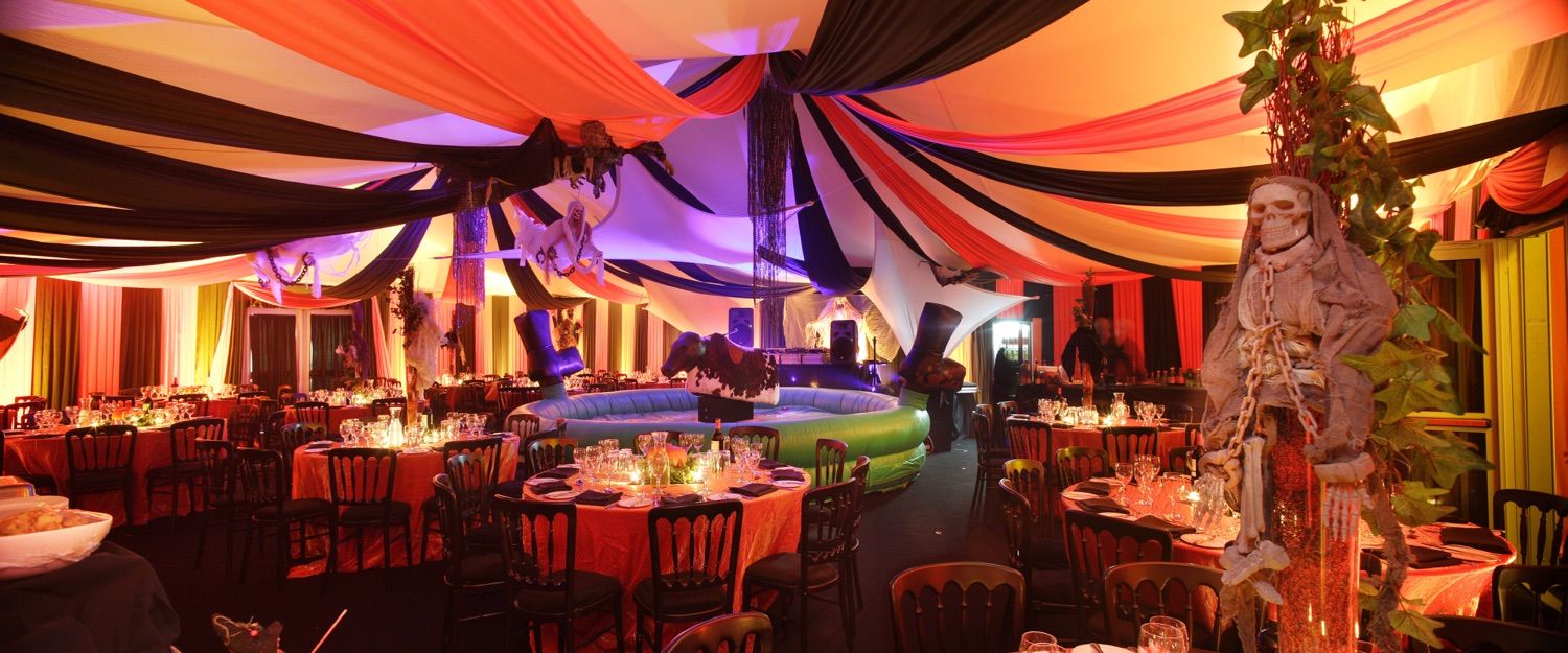 Marquee decor , table setting and lighting for a private party with a Hallowneen theme