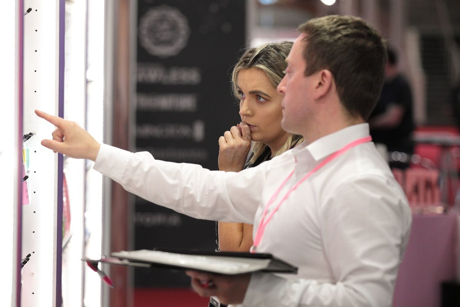 A staff memnber helps a customer with some advice during a trade show/exhibition in the RDS main hall, Dublin