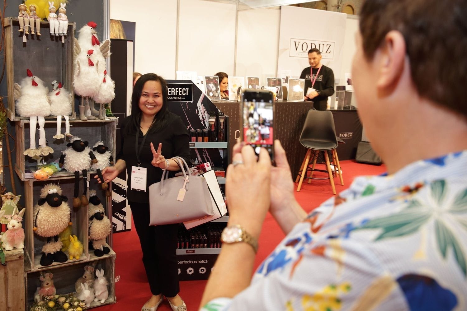 A lady poses at a display of furry animals at an industry trade show in the RDS main hall, Dublin