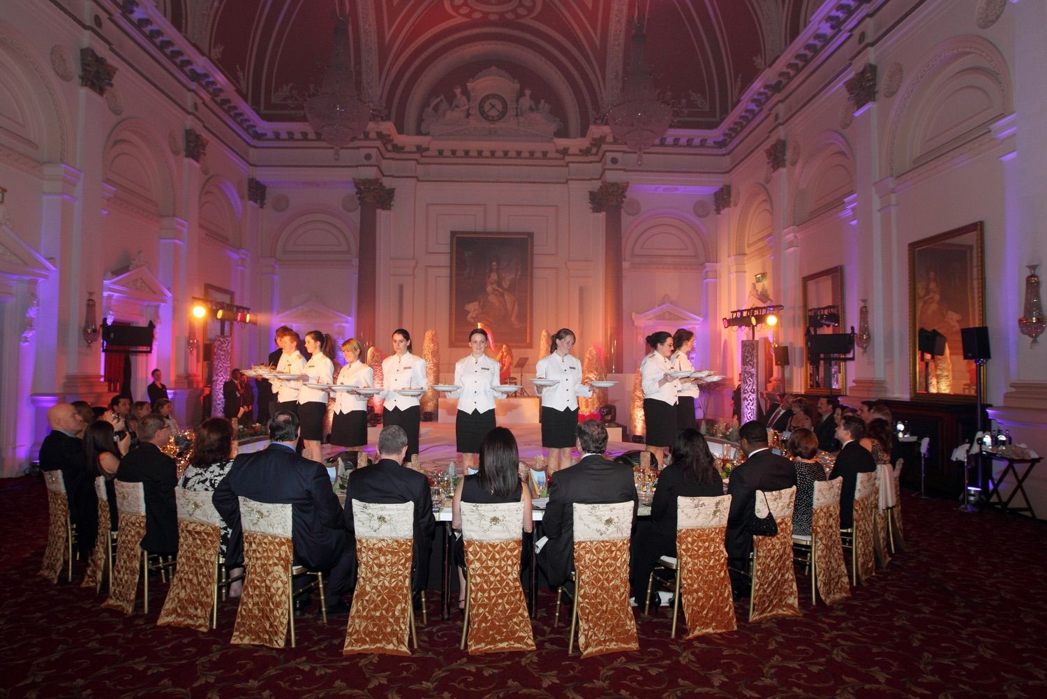 Dinner service at an exclusive party in front of the portrait in the banking hall of the College Green Hotel, Dublin