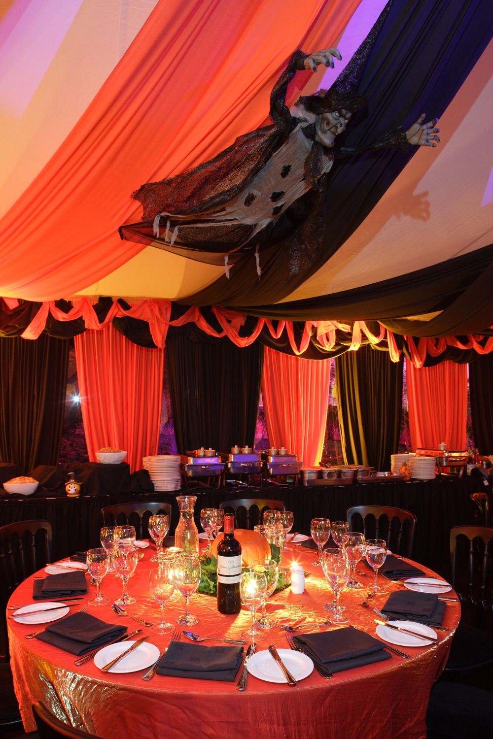 Marquee decor , table setting and lighting for a private party with a Hallowneen theme